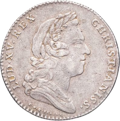 gros plan d'une pièce de monnaie sur laquelle figure une tête de femme