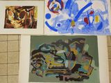 three paintings on a tile floor one is blue and the other is yellow