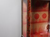 a display case with a doll in it on a stand