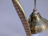 a metal lamp with a bird on it ' s head