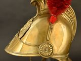 an image of a helmet with a red feather on top of it