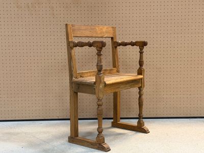 a wooden chair that is sitting in front of a wall