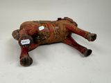 an old red and brown cow laying on its back with a tag on it ' s neck