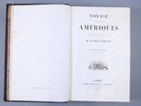 an open book with a picture of an old building in the background