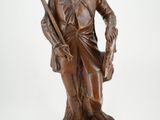 statue en bronze représentant un homme armé d'un pistolet et coiffé d'un chapeau
