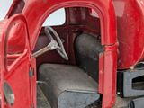a red toy truck that is sitting on a white surface