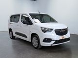 the small white van is parked in a large room