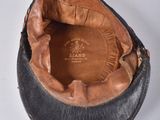 a black hat with a brown leather lining on it