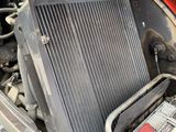a radiator in the engine bay of a car