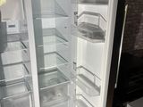 an open refrigerator with its door open in a kitchen