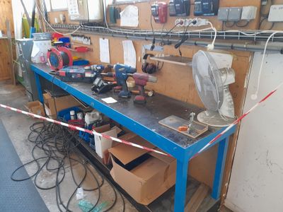 a blue workbench with tools on it in a garage