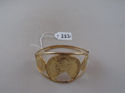 an image of a gold ring with a coin in the middle