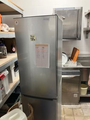 stainless steel refrigerator in a commercial kitchen with shelves and shelves