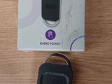 a box with a remote control and a keychain on a table