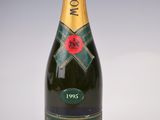 a close up of a bottle of champagne on a white surface