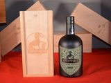 a bottle of wine sitting next to a wooden box