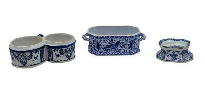 trois pièces de poterie bleue et blanche posées sur une surface blanche