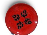 a red frisbee with a black design on it