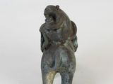 a statue of a bear holding a baby on its back