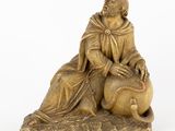 an image of a statue of a man sitting on top of a sheep