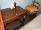 a small wooden table with a chair next to it