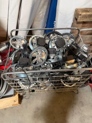 a metal basket filled with assorted items in a garage
