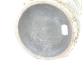 a close up of a vase on a white surface