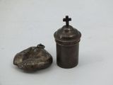 a small metal object with a cross on it
