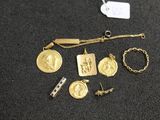 a close up of a bunch of gold jewelry on a table