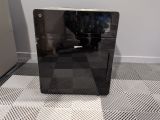 a black computer sitting on top of a black and white checkered floor