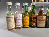 many different types of alcohol bottles lined up on the counter
