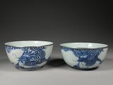 pair of blue and white bowls with dragon design