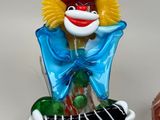 two figurines of clowns sitting next to each other