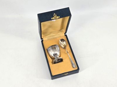 a silver spoon and a spoon in a box