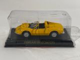 yellow ferrari dino 246 gts model car in a clear display case