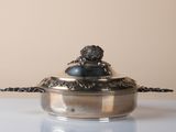 a silver plate with a lion on it on a table