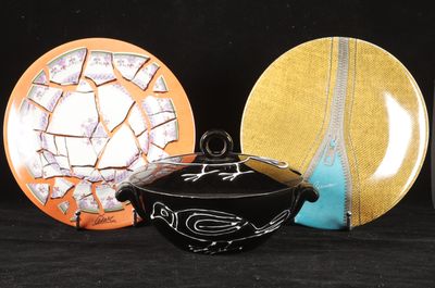 three plates and a bowl sitting next to each other on a table