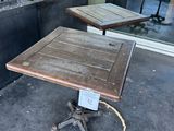 two tables on the sidewalk outside of a restaurant