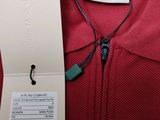 the back of a red polo shirt with a white tag on it