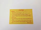 a yellow sign on the back of a white refrigerator