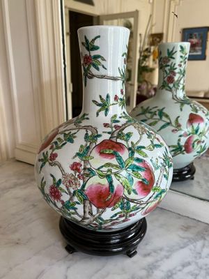 two vases that are sitting on a marble table