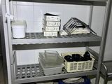 a metal shelf with dishes on it in a kitchen