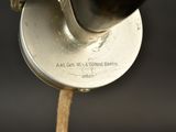 a close up of a metal object with a wooden handle