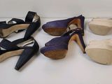 four pairs of women ' s shoes are lined up on a white surface