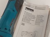 a blue and black tool sitting on top of a piece of paper