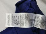 a label on the back of a blue shirt