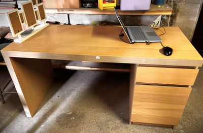 a desk with a laptop on top of it