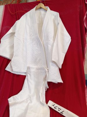 a white robe on a red blanket next to a sign