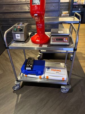 an image of a red coffee machine on a metal cart
