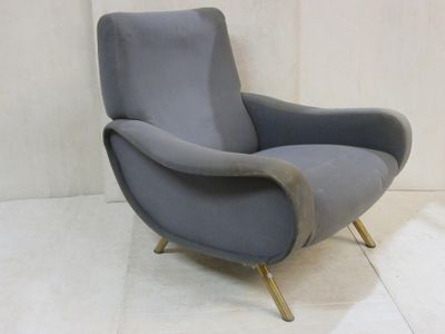 a grey chair that is sitting on a white floor